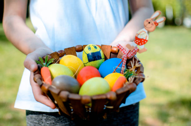 istock Child with basket full of painted Easter eggs 1298376101