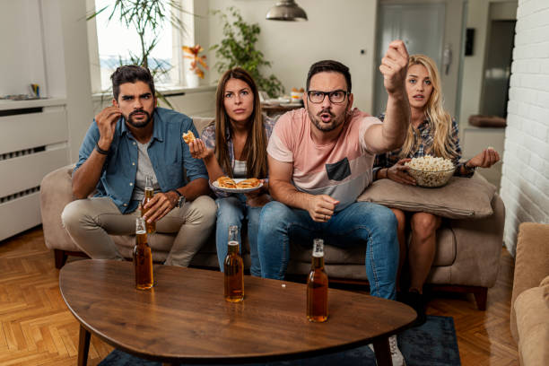 istock Friends watching sport on tv 1298380064