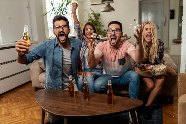 istock Friends watching sport on tv 1298380127