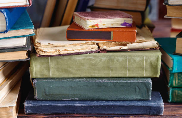 istock Stack of old vintage books on wooden shelf in  university library 1298380683