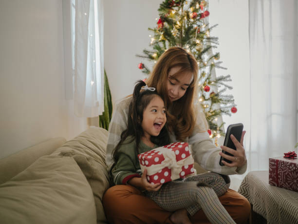 istock Mother and daughter making a video conference at Christmas time 1298384523