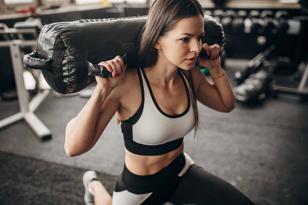 istock Fit woman training with weights in gym 1298385462