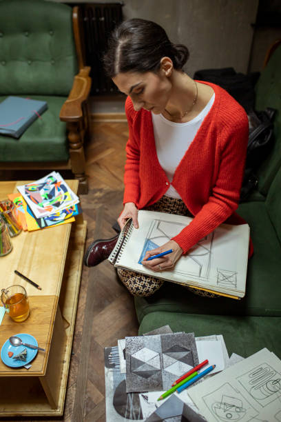 istock Beautiful freemale freelance artist drawing on a paper 1298391285