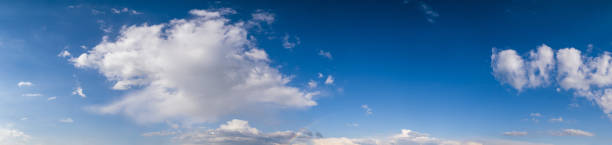 istock White cumulus  clouds and rainbow in summer evening  blue sky panoramic high resolution background 1298396753