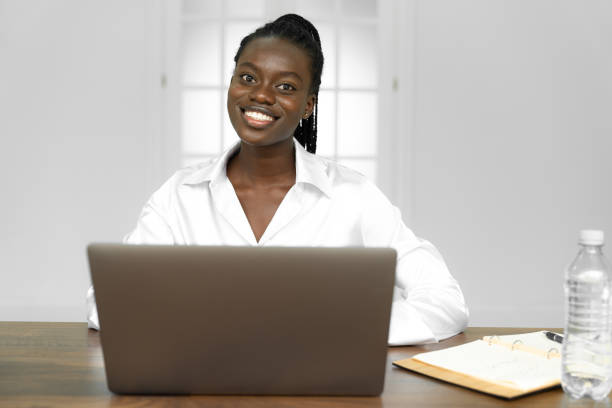 istock Cheerful african american freelancer smiling at camera while working on laptop 1298398772