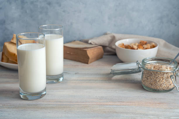 istock Grocery background with milk, oatmeal and bread on a gray background 1298398899