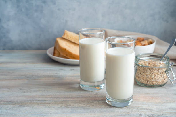 istock Fresh milk, oatmeal and bread on a gray background. Side view with copy space 1298401017