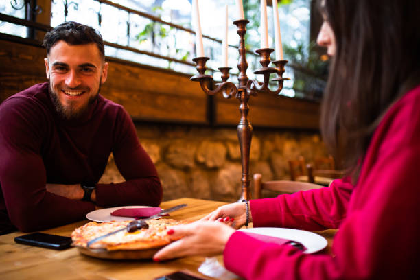 istock An attractive couple out for dinner at a restaurant 1298404812