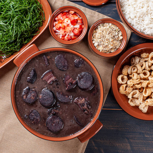 istock Typical Brazilian dish called Feijoada. Made with black beans, pork and sausage. Top view 1298405139