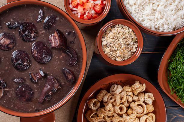 istock Typical Brazilian dish called Feijoada. Made with black beans, pork and sausage. Top view 1298405327
