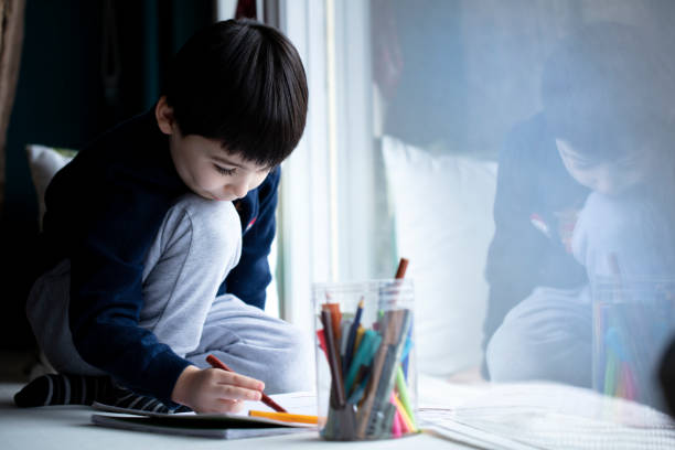 istock little boy drawing a picture at home 1298405752