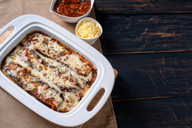 istock Eggplant parmigiana with cheese and tomato sauce. Top view. Copy space 1298406848