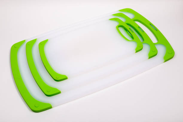 istock Set of white kitchen cutting boards with green handles for cooking. 1298407725