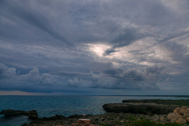 istock A calm sunset on a dark blue sea. Thick clouds on the horizon 1298407783