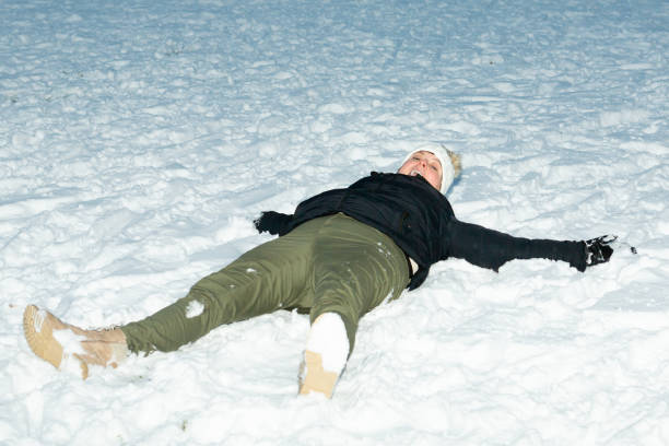 istock Lady have fun lying down on the snow 1298408908