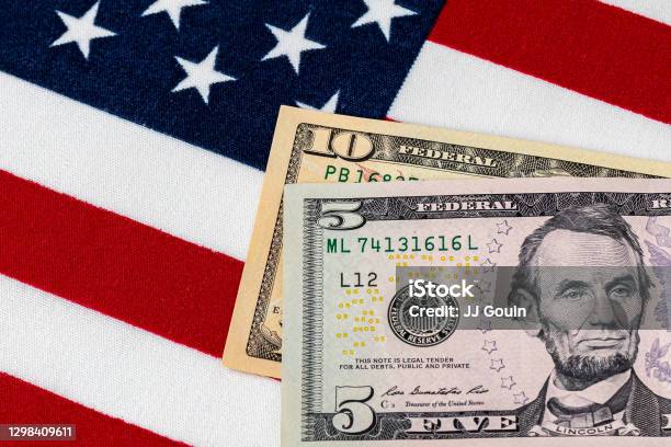 Closeup Of Ten And Five Dollar Bills With American Flag Concept Of 15 Dollar Federal Minimum Wage Increase Stock Photo - Download Image Now