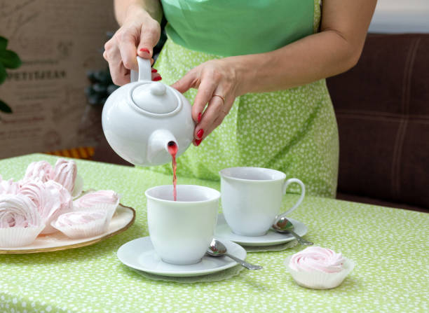 istock In a white mug, pour tea for a tea party with marshmallows. Selective focus. 1298410937
