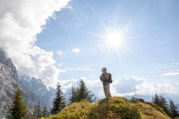 istock Hiker pauses on mountain meadow on a sunny day 1298411089