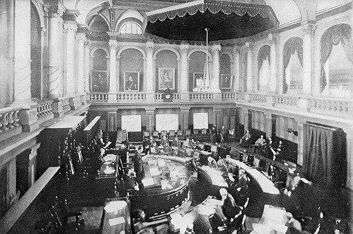 The politicians of the Volksraad at the Ou Raadsaal in Pretoria, South Africa. Vintage photo etching circa 19th century. At this time it was the home of the Volksraad (People’s Council).