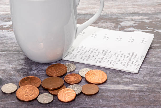 istock Shopping receipt with some coins 1298413933