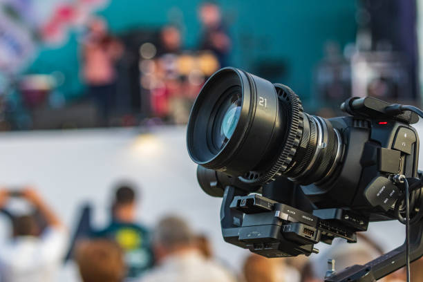istock Professional video equipment mounted on a tripod in a city park. 1298414830