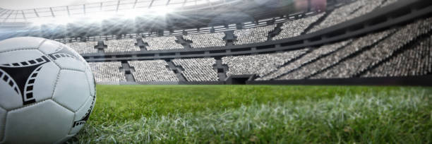 istock Composite image of soccer ball on white marking line 1298415809