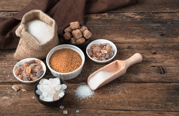 istock Different types of sugar on a natural wooden background 1298417624