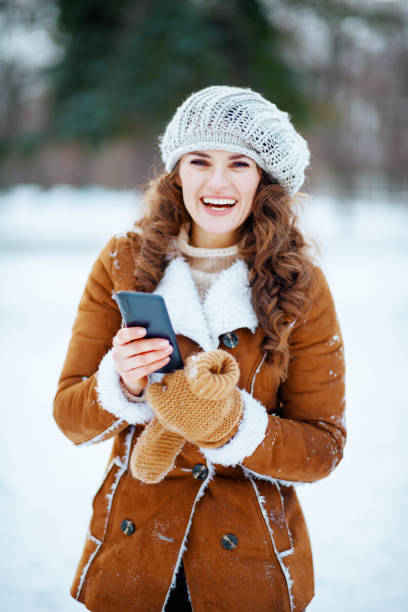 istock happy stylish female sending text message using smartphone 1298417785