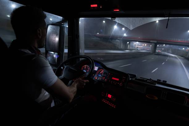 bel autista al volante di un camion di notte. - night drive foto e immagini stock