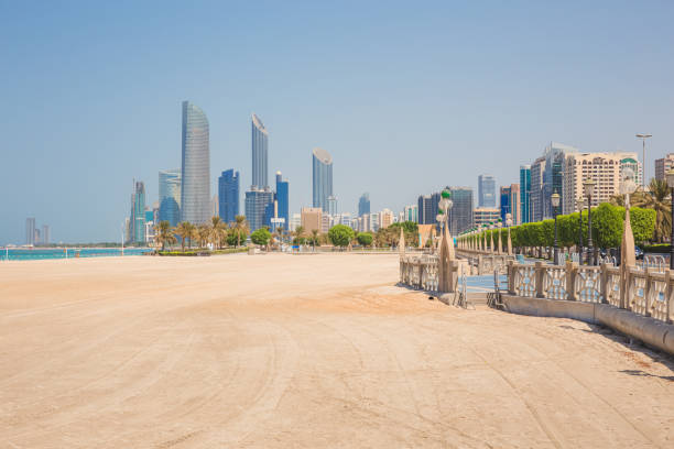 Corniche Beach. Abu Dhabi, UAE An empty view with no people down Corniche Beach and promenade with cityscape of Abu Dhabi, UAE. arabian peninsula stock pictures, royalty-free photos & images