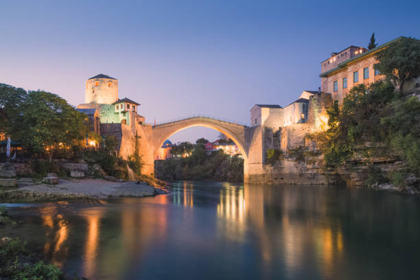 Evening, blue hour view of the iconic Stari Most bridge, Neretva River and old town of Mostar, Bosnia and Herzegovina.