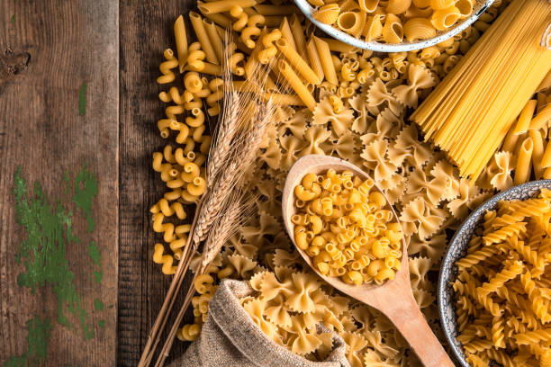 istock Spread out on a wooden table pasta of different types 1298423790