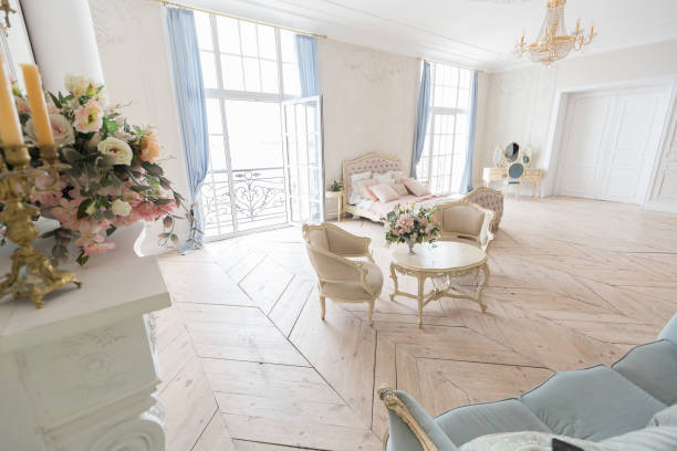 istock luxurious light interior in the Baroque style. A spacious room with a road chic beautiful furniture, a fireplace and flowers. plant stucco on the walls and light wood parquet 1298424622