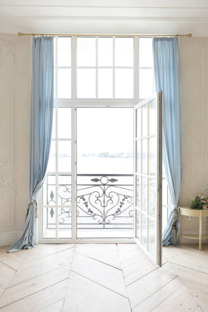 istock luxurious light interior in the Baroque style. A spacious room with a road chic beautiful furniture, a fireplace and flowers. plant stucco on the walls and light wood parquet 1298424648