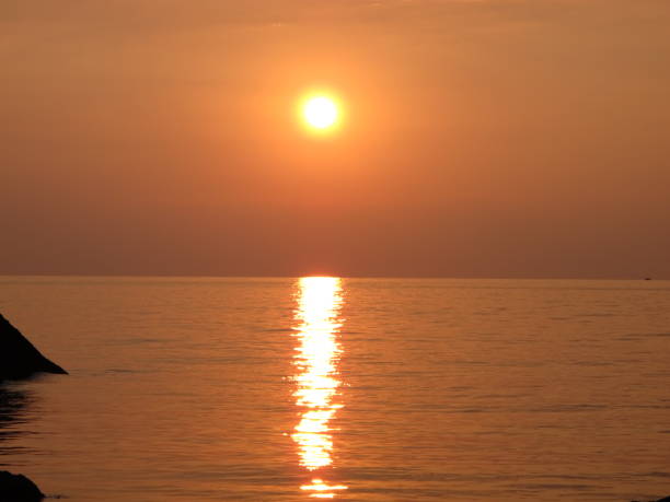 istock Bronze orange sunset on the sea coast on a summer evening 1298424710