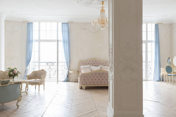 istock luxurious light interior in the Baroque style. A spacious room with a road chic beautiful furniture, a fireplace and flowers. plant stucco on the walls and light wood parquet 1298424723
