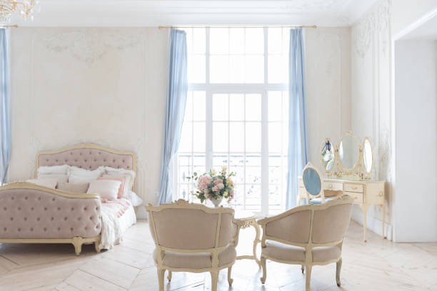 istock luxurious light interior in the Baroque style. A spacious room with a road chic beautiful furniture, a fireplace and flowers. plant stucco on the walls and light wood parquet 1298424754