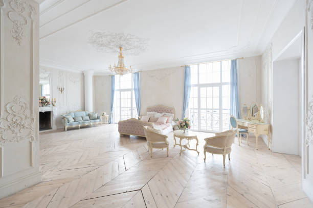istock luxurious light interior in the Baroque style. A spacious room with a road chic beautiful furniture, a fireplace and flowers. plant stucco on the walls and light wood parquet 1298424781