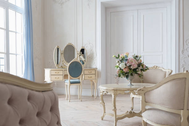 istock luxurious light interior in the Baroque style. A spacious room with a road chic beautiful furniture, a fireplace and flowers. plant stucco on the walls and light wood parquet 1298424853