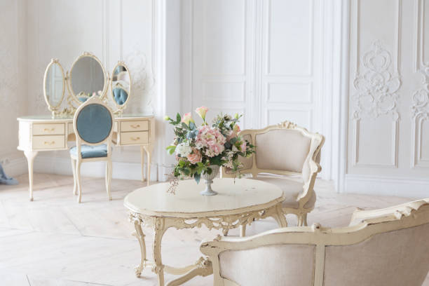istock luxurious light interior in the Baroque style. A spacious room with a road chic beautiful furniture, a fireplace and flowers. plant stucco on the walls and light wood parquet 1298424865