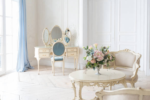 istock luxurious light interior in the Baroque style. A spacious room with a road chic beautiful furniture, a fireplace and flowers. plant stucco on the walls and light wood parquet 1298424870
