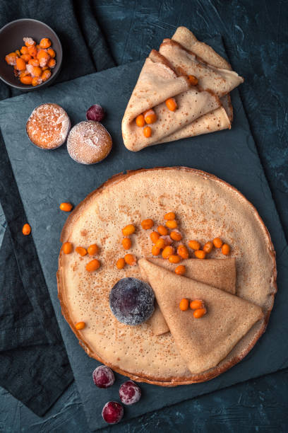 istock Fried pancakes and berries on a dark background. Top 1298425168