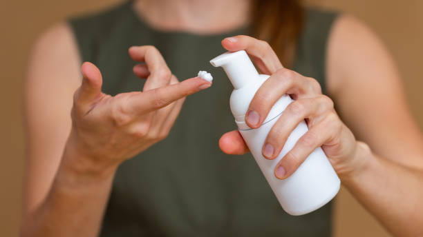 istock Close-up of a woman using hand moisturizing cream 1298425974