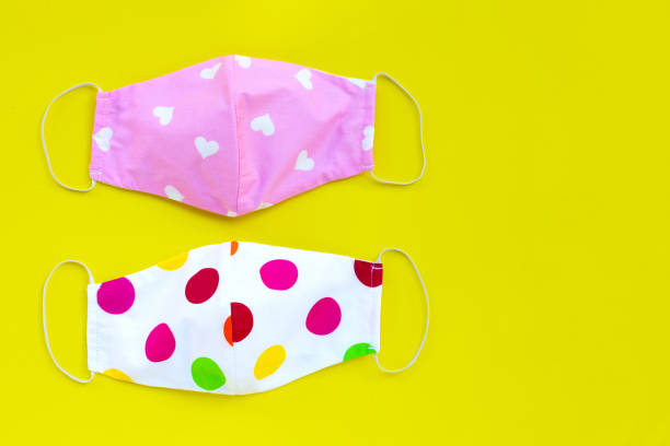 istock Handmade colorful cloth masks on yellow background. 1298426180