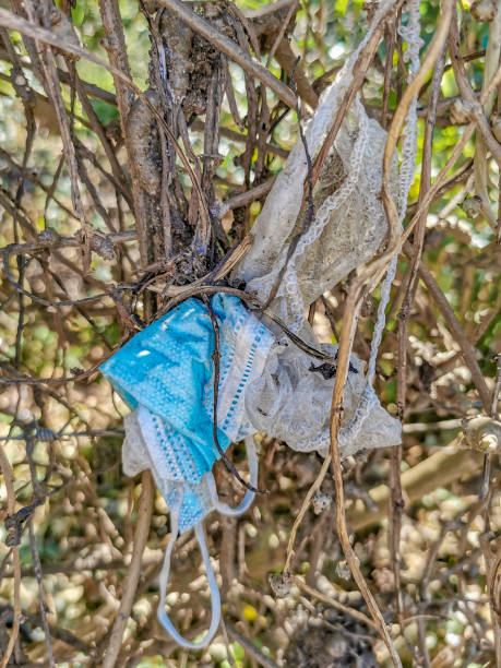istock Surgical masks in nature. Corona virus pollution. Covid19. 1298426199