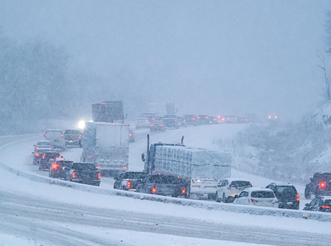 Rush hour traffic is delayed during heavy snowfall.