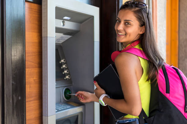 istock Woman in front of an ATM 1298427180