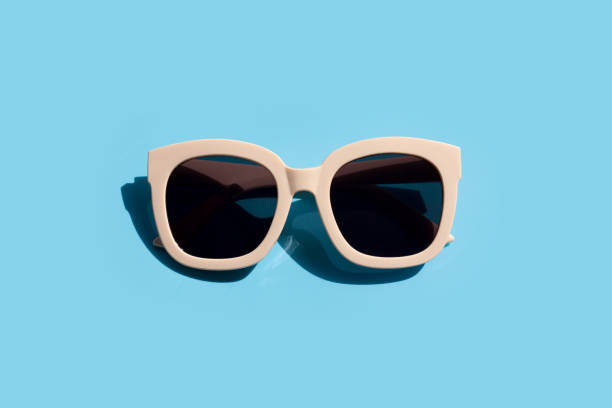 istock Sunglasses on blue background. Enjoy holiday concept. 1298430403