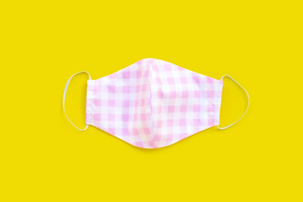istock Handmade colorful cloth mask on yellow background. 1298430423
