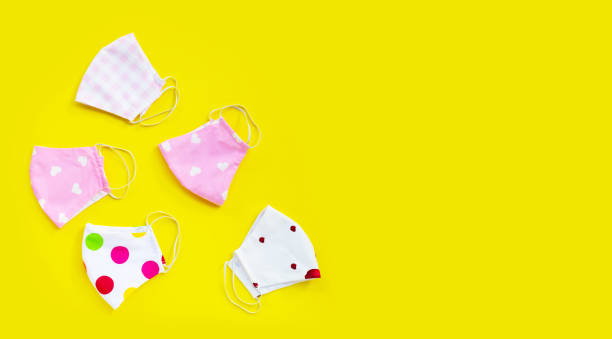 istock Handmade colorful cloth masks on yellow background. 1298431816
